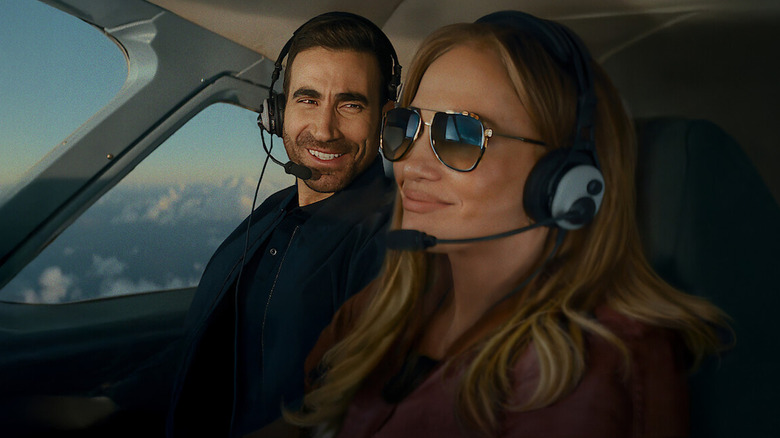 Jackie and Daniel smile in a plane in 