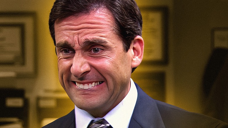 close-up of Michael Scott from The Office cringing.