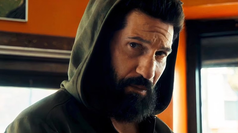 Frank Castle wearing a hooded sweatshirt and glancing to the side in The Punisher: One Last Kill